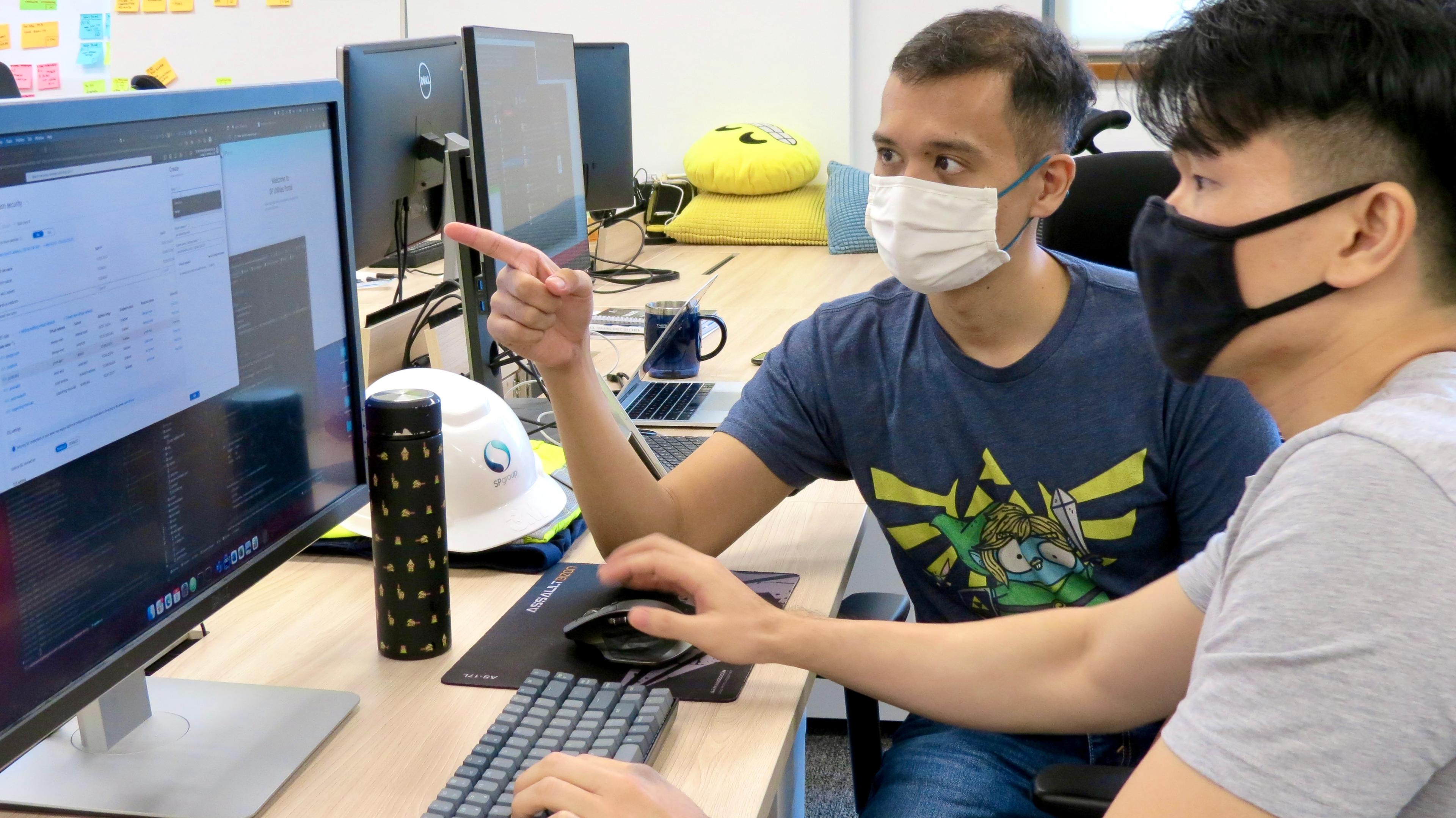 Ibrahim and his colleague, Senior Software Engineer Wong Yat Hong working on monitoring of cloud systems.