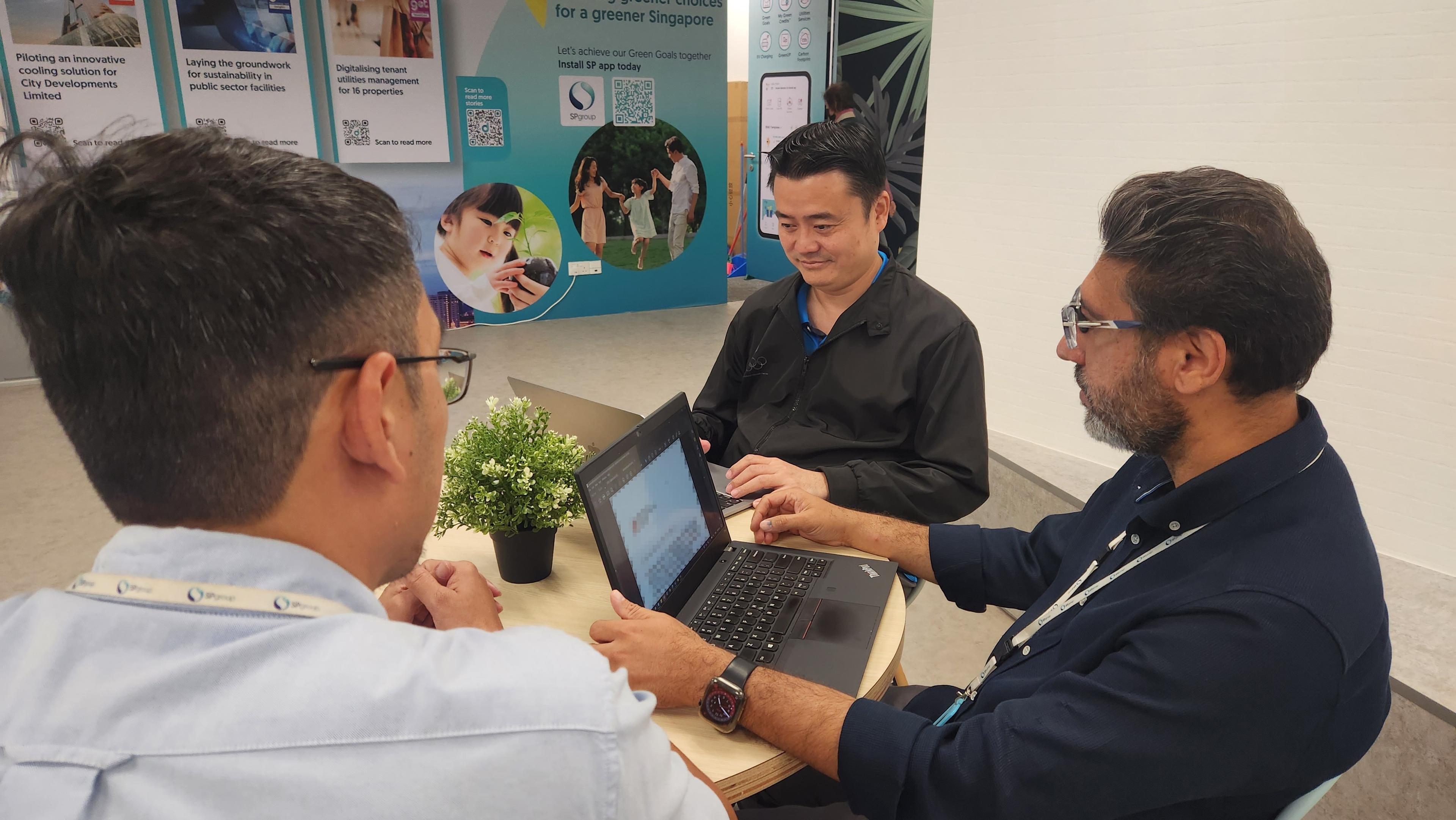 Head of Sales of SP Digital, Satinderpal Singh (right), discussing the implementation of Green Energy Tech solutions with his colleagues.