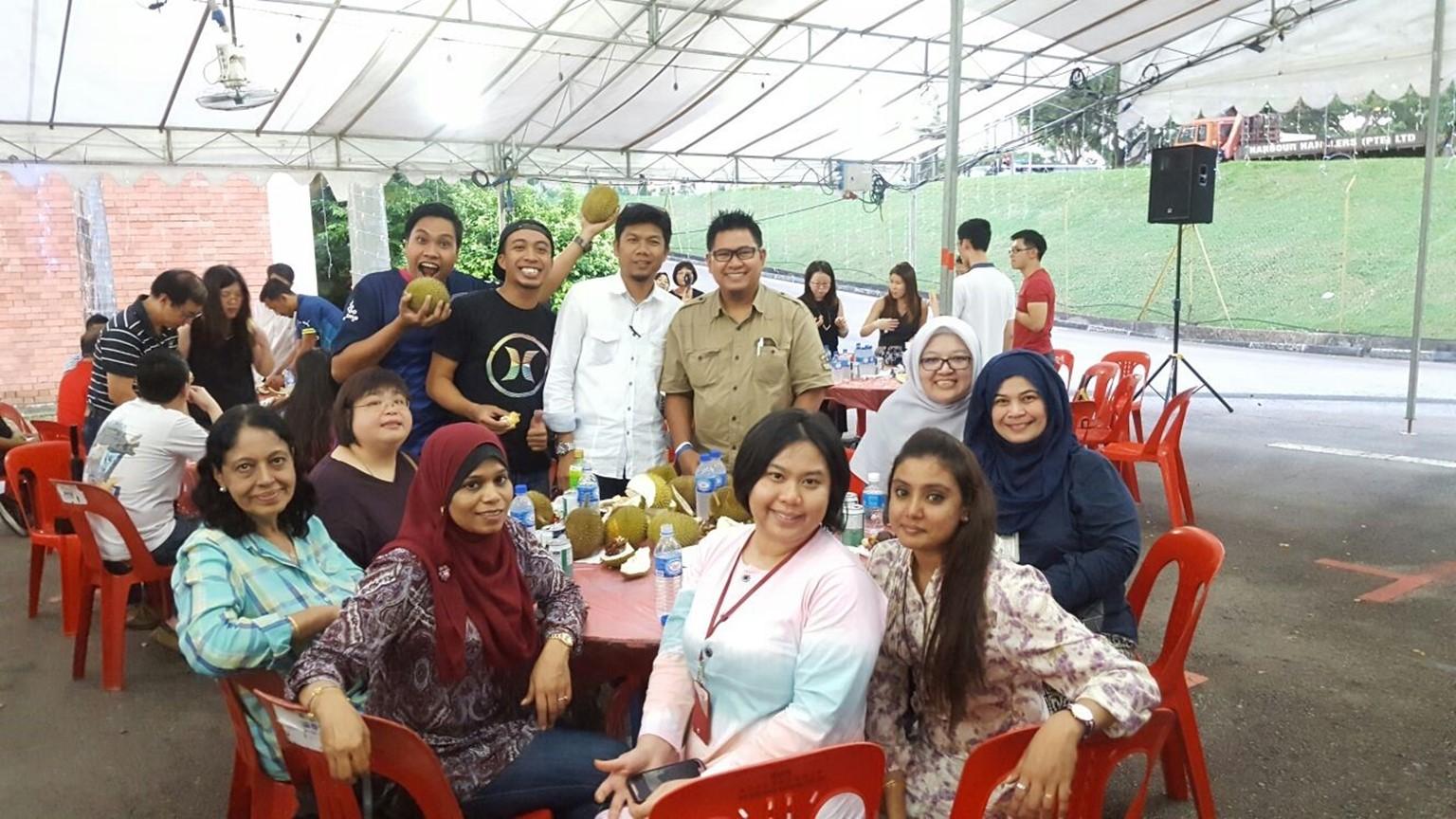 Maizan (in blue attire) and her former colleagues from Meters section enjoying a durian feast together.