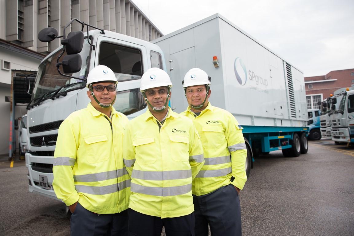Mohamed Nasir bin Mohamed Ismail, Technical Officer, Electricity Operations (center) together with Ismet Imran bin Chuma'ing, Senior Technician, Electricity Operations (left) and Mohammad Najib bin Jalil, Technical Officer, Electricity Operations (right) from SP Group's Mobile Generator Unit.