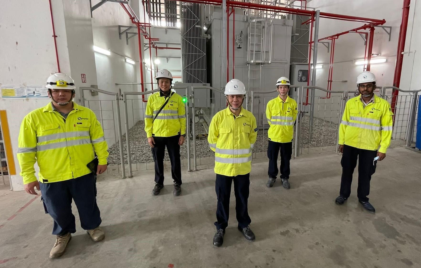 Seng Kok (centre) with engineers from SP PowerGrid at a substation.