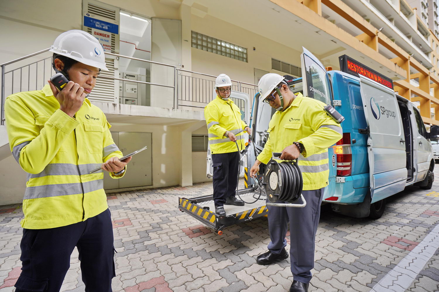 (From left) Principal Engineer Jerome Choong with Service Technicians Hasly Bin Hashim and Mohammad Iskandar bin Sapari attending to an incident at an affected substation.