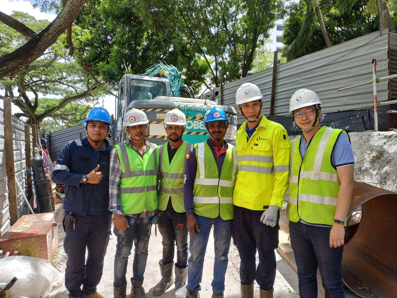 Louis (extreme right) in the field with contractors.
